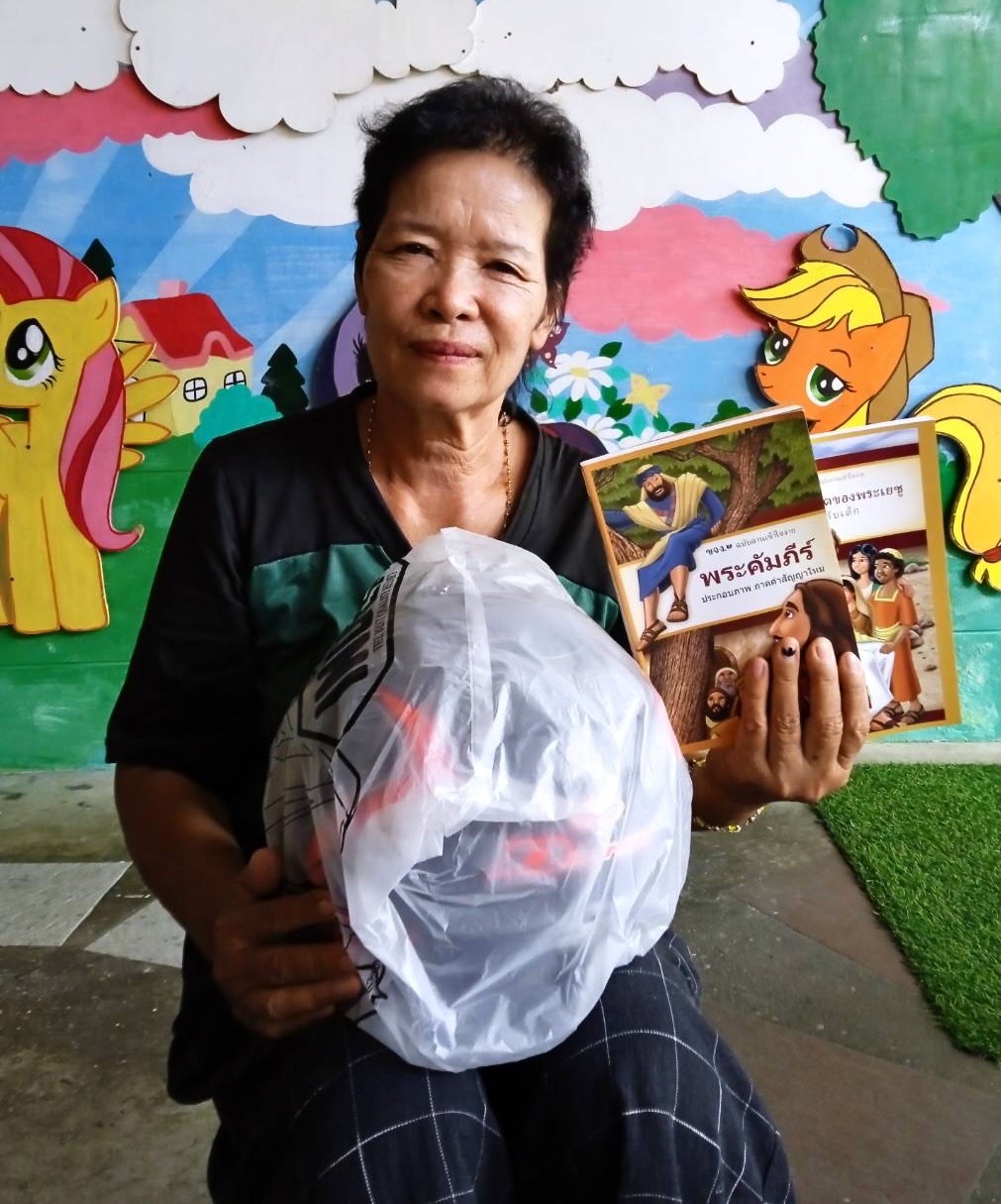 Helmet & New Testament presented to this Thai lady